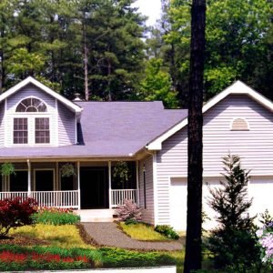 Exterior front view of The Copley, a traditional two-story home with wrap-around porch and gabled roofline.