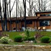 Exterior view of the Eagle’s Nest contemporary kit home with wood siding and expansive windows.
