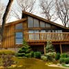 High Knob kit home exterior with wood siding, large deck, and angled roofline