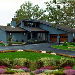Prospect Bay contemporary kit home with dark siding and large driveway